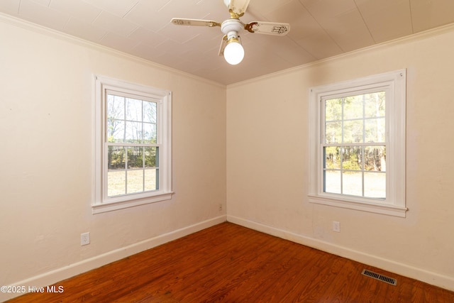 spare room with hardwood / wood-style floors, plenty of natural light, ornamental molding, and ceiling fan