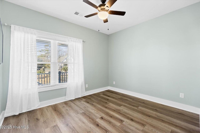 unfurnished room with ceiling fan and wood-type flooring