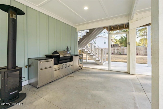 view of patio / terrace featuring exterior kitchen and a grill