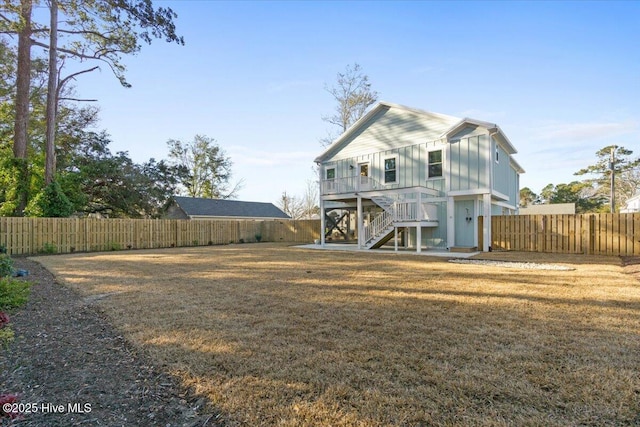 rear view of property with a lawn