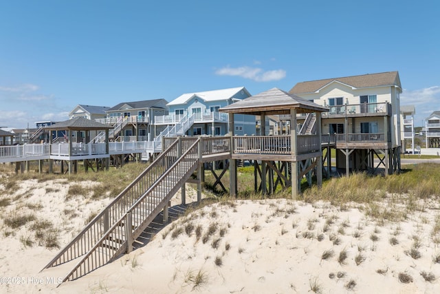 1280 New River Inlet Rd, North Topsail Beach, NC 28460 - back of house with a gazebo, stairs, and a residential view