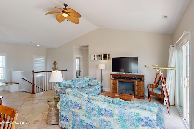 living room with light tile patterned floors, ceiling fan, and lofted ceiling