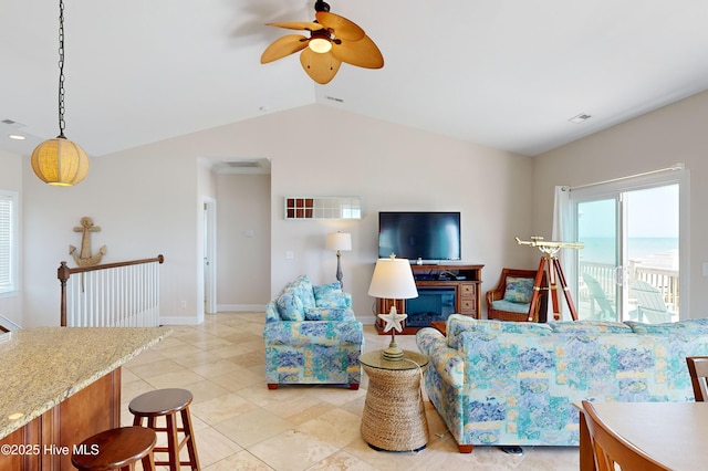 living room with ceiling fan, light tile patterned flooring, and lofted ceiling