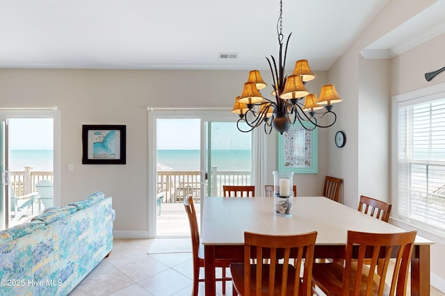 1280 New River Inlet Rd, North Topsail Beach, NC 28460 - dining space featuring a chandelier, plenty of natural light, light tile patterned floors, and a water view