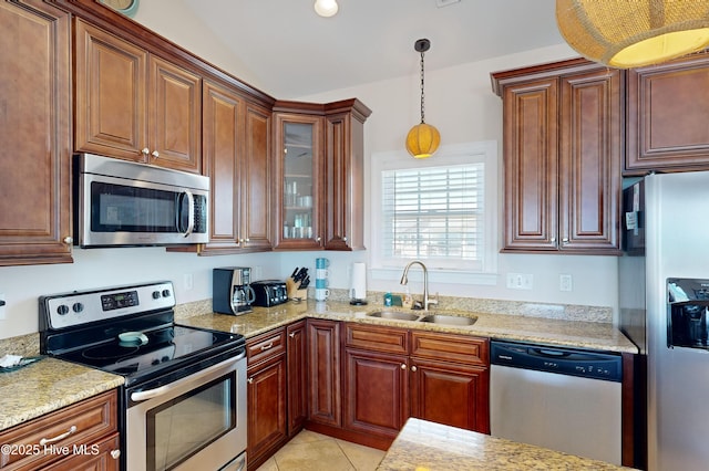 1280 New River Inlet Rd, North Topsail Beach, NC 28460 - kitchen with appliances with stainless steel finishes, pendant lighting, glass insert cabinets, light tile patterned floors, and light stone countertops