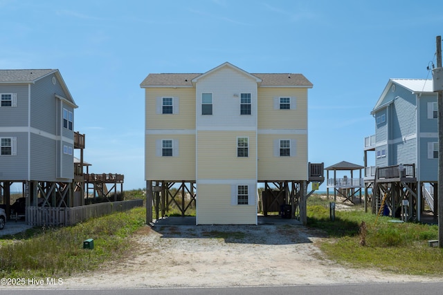1280 New River Inlet Rd, North Topsail Beach, NC 28460 - rear view of house featuring a carport, driveway, and roof with shingles