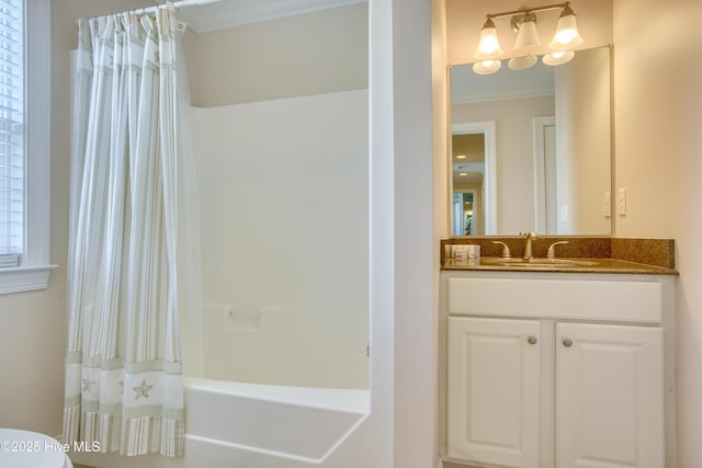 bathroom with crown molding, vanity, and shower / bath combo