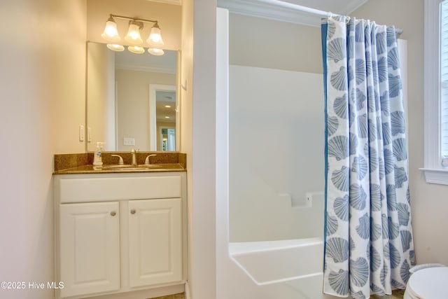 full bathroom featuring shower / bath combo with shower curtain, vanity, toilet, and crown molding