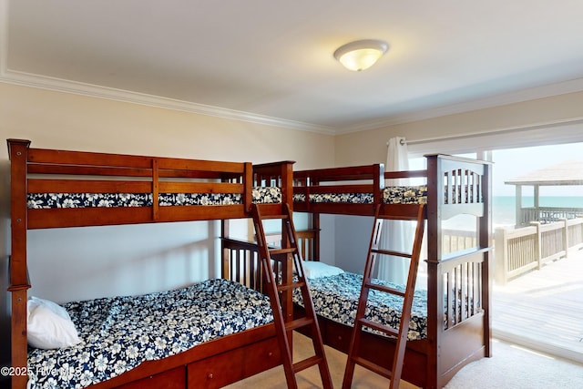 bedroom featuring carpet flooring, a water view, and crown molding