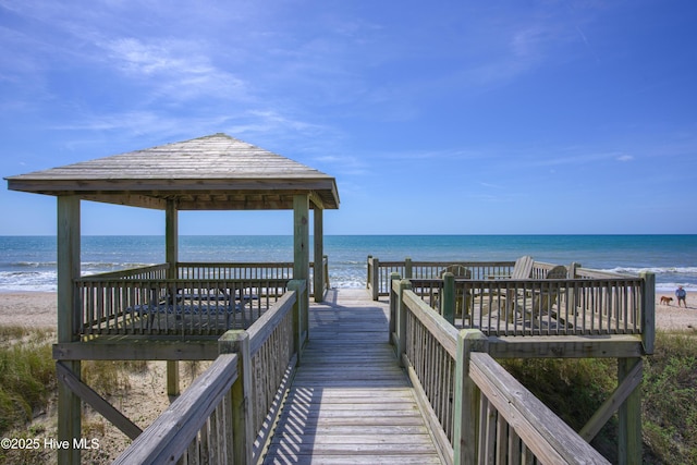 view of home's community with a view of the beach, a gazebo, and a water view