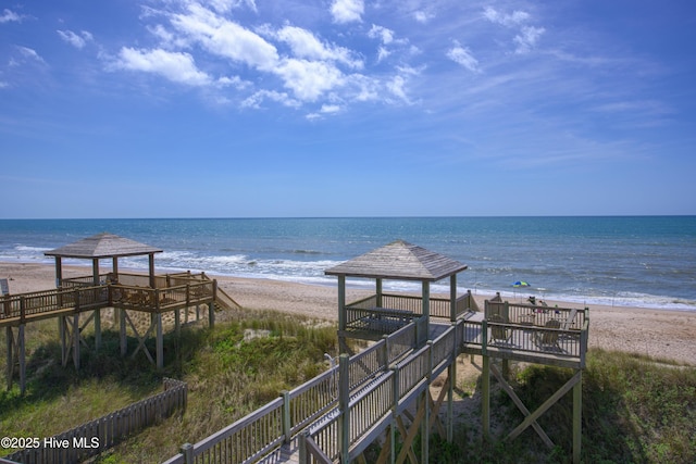 property view of water featuring a gazebo and a beach view