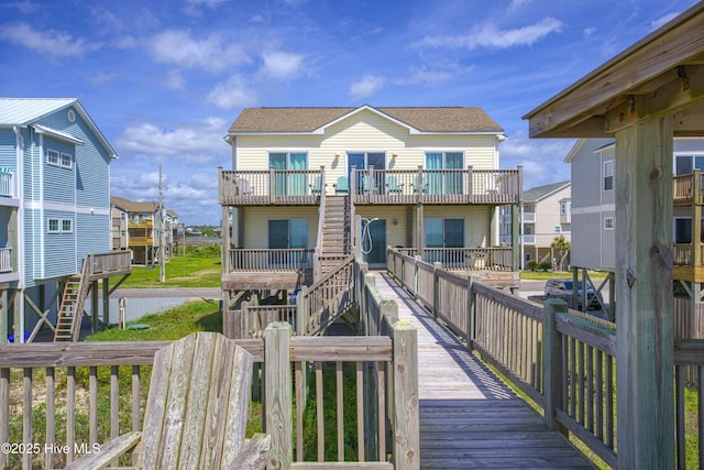 1280 New River Inlet Rd, North Topsail Beach, NC 28460 - back of house with stairway, a shingled roof, and a deck