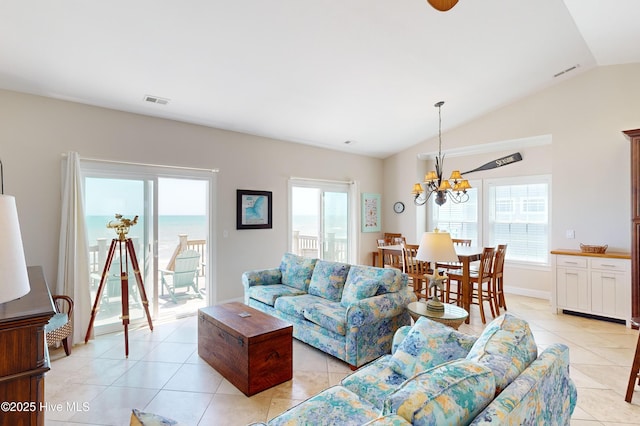 1280 New River Inlet Rd, North Topsail Beach, NC 28460 - living room with light tile patterned floors, healthy amount of natural light, lofted ceiling, and a chandelier