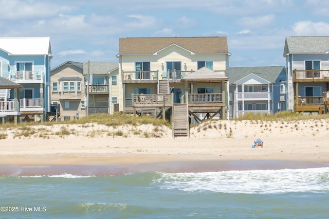 exterior space featuring a beach view and a water view