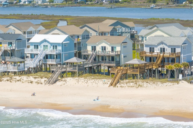 drone / aerial view with a water view and a view of the beach