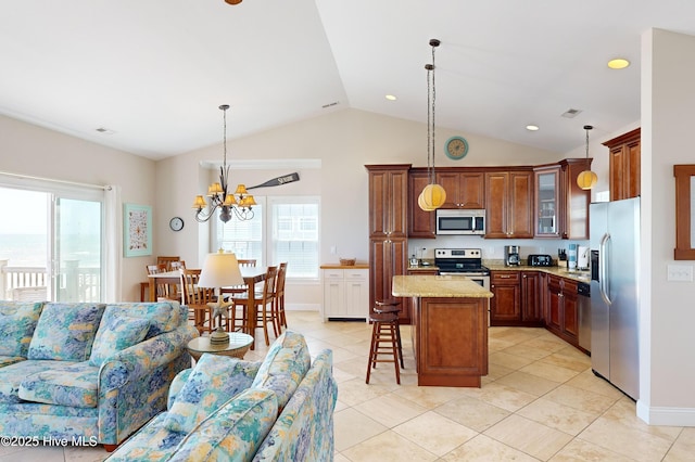 kitchen featuring hanging light fixtures, a notable chandelier, plenty of natural light, a breakfast bar area, and appliances with stainless steel finishes