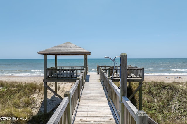 view of home's community featuring a beach view, a gazebo, and a water view