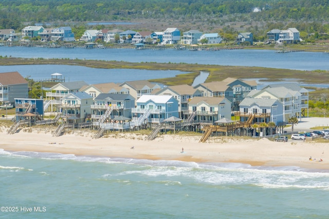 bird's eye view with a water view and a view of the beach