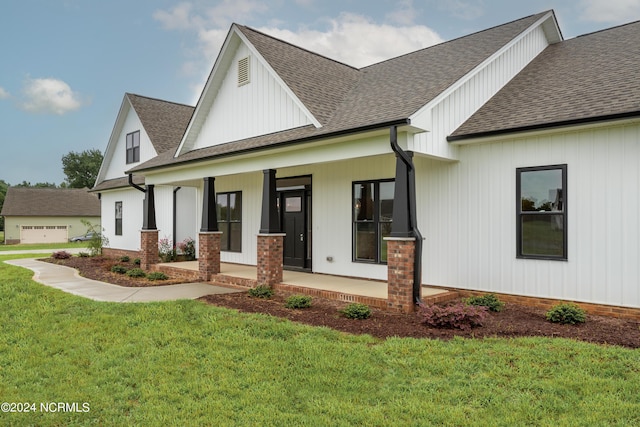 modern farmhouse featuring a front yard and a porch