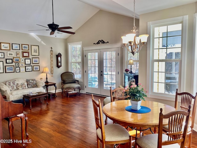 dining room with french doors, lofted ceiling, dark hardwood / wood-style flooring, and ceiling fan with notable chandelier