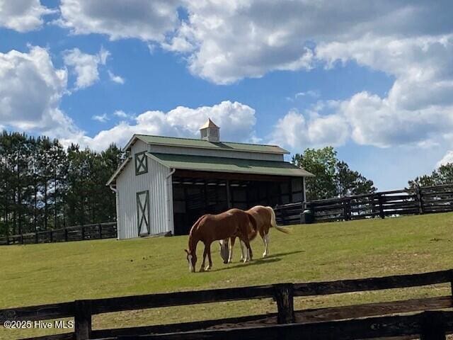 view of stable featuring a rural view