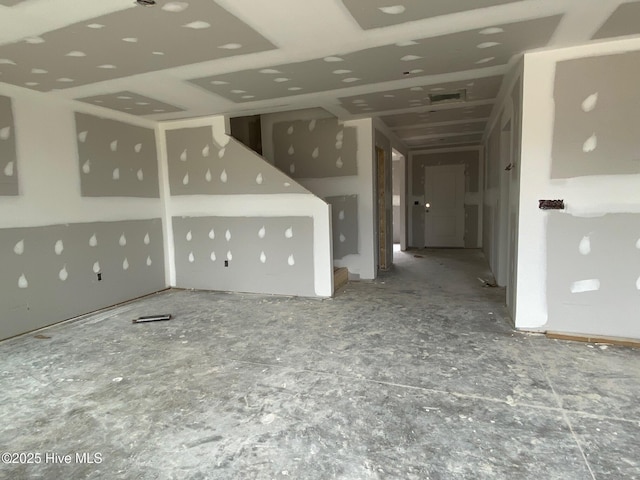 unfurnished living room with visible vents