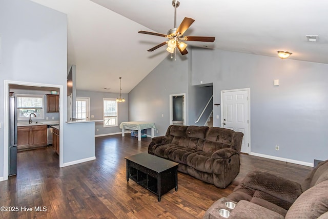 living room featuring dark hardwood / wood-style flooring, sink, high vaulted ceiling, and ceiling fan