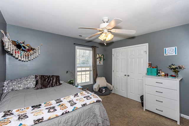 carpeted bedroom with ceiling fan and a closet