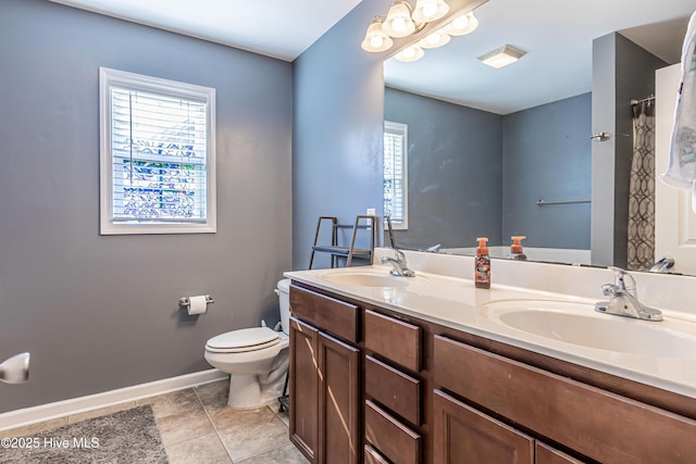 bathroom featuring vanity, toilet, and tile patterned flooring