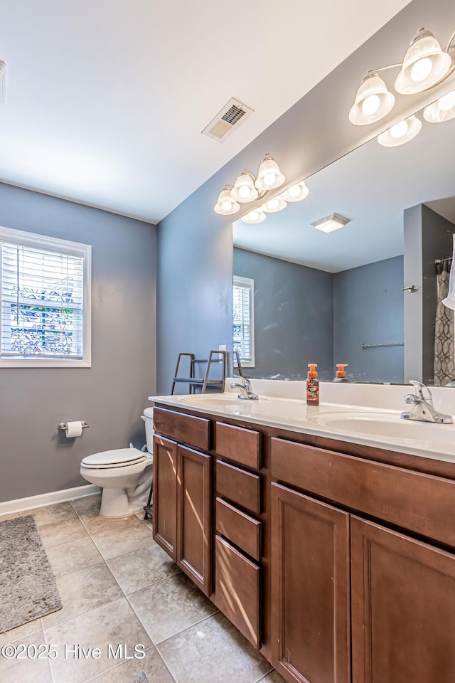 bathroom with tile patterned floors, vanity, and toilet