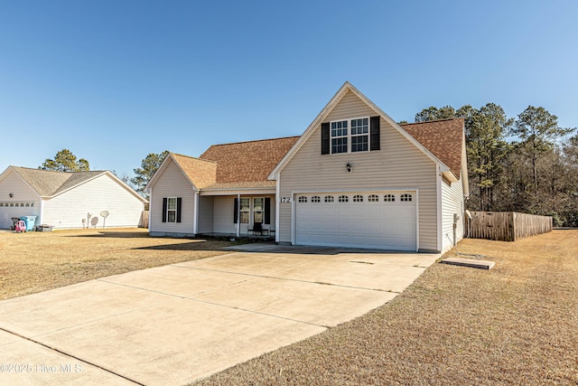 view of front of property with a garage and a front lawn