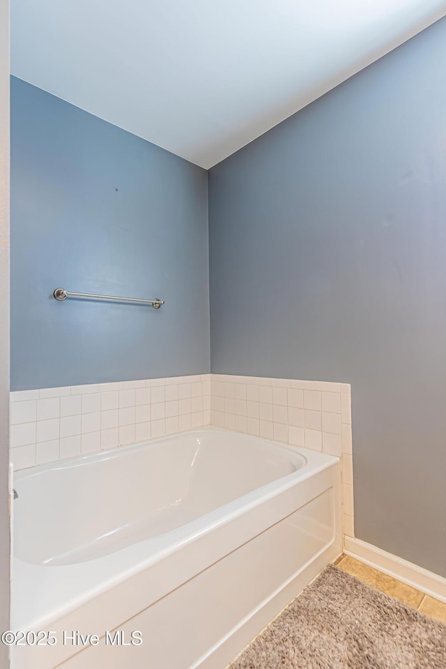 bathroom featuring tile patterned floors and a tub