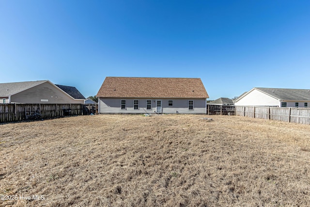 back of house featuring a yard