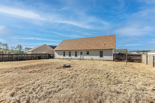 back of property featuring a yard