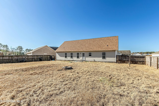 rear view of house featuring a yard