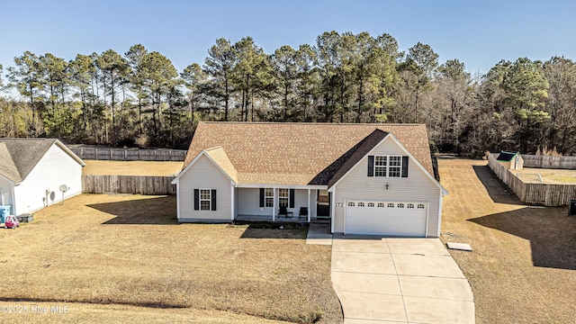 view of front of property with a garage, a front lawn, and covered porch