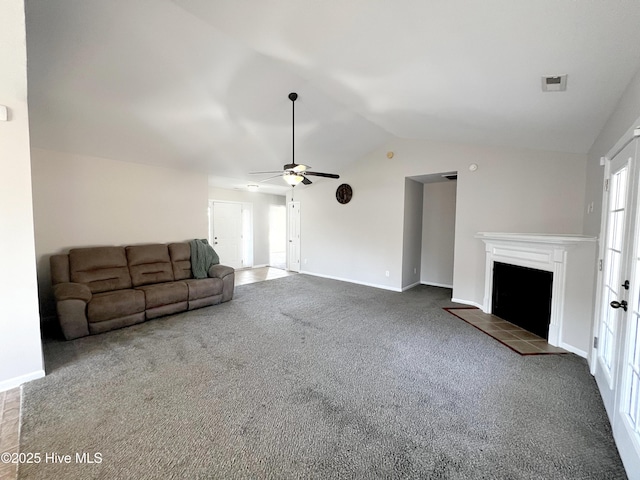 unfurnished living room with carpet, ceiling fan, a tile fireplace, and vaulted ceiling