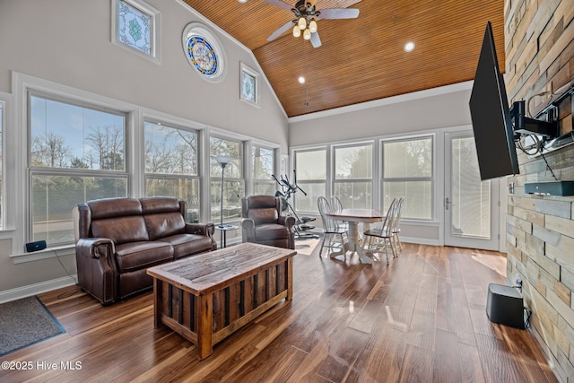 living room with wood ceiling, crown molding, hardwood / wood-style flooring, ceiling fan, and a high ceiling