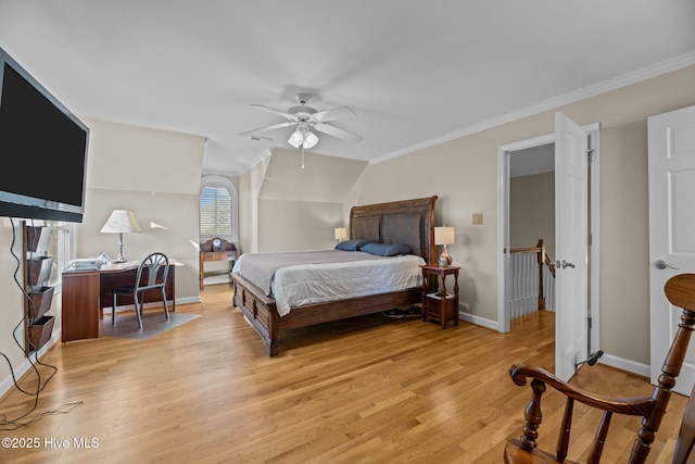 bedroom featuring crown molding, ceiling fan, and light wood-type flooring