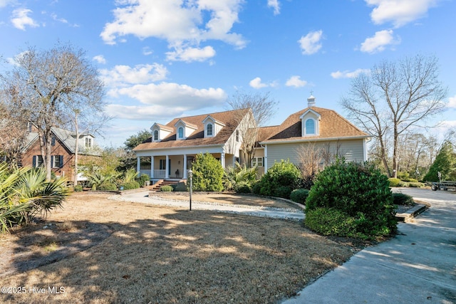 cape cod-style house with covered porch