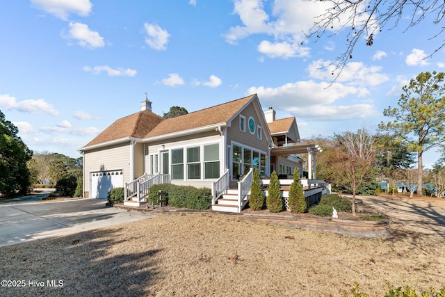 view of front of house featuring a pergola and a garage