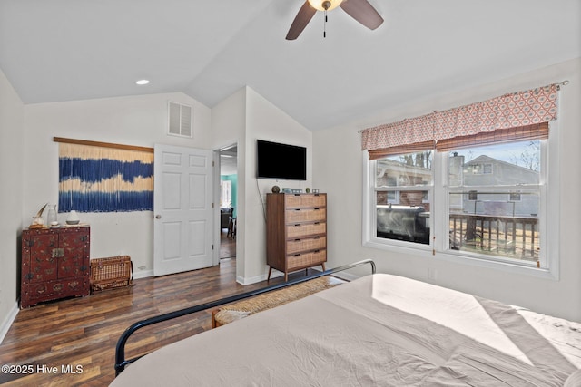 bedroom featuring ceiling fan, dark hardwood / wood-style flooring, and lofted ceiling