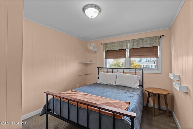 bedroom with crown molding and hardwood / wood-style floors