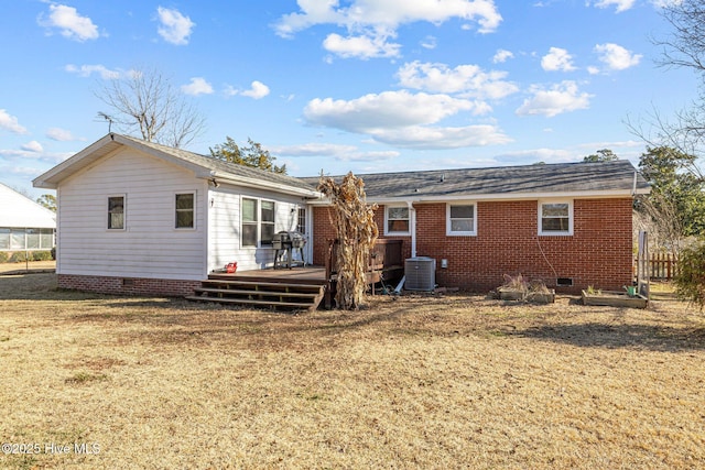 rear view of house with a wooden deck, a yard, and central AC