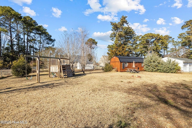 view of yard featuring a playground and a storage unit