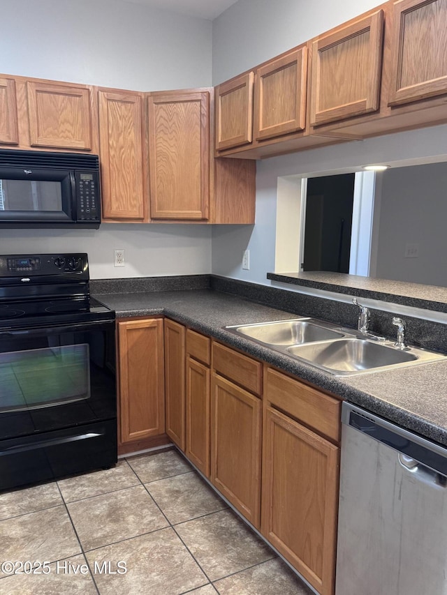 kitchen featuring black appliances, light tile patterned floors, and sink