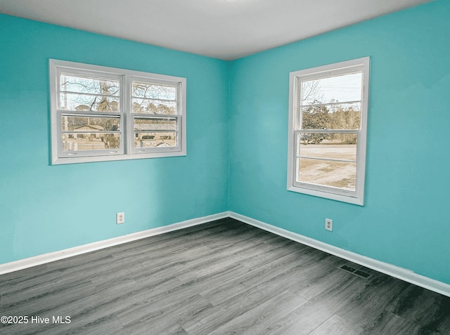 unfurnished room with wood-type flooring