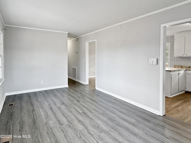 unfurnished living room with light wood-type flooring and crown molding