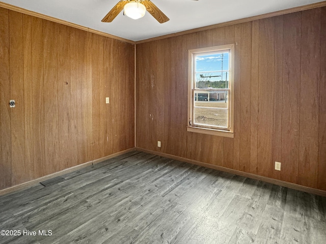 spare room with ceiling fan, hardwood / wood-style floors, and crown molding