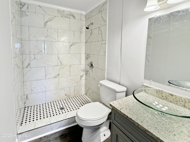 bathroom with vanity, walk in shower, toilet, and ornamental molding